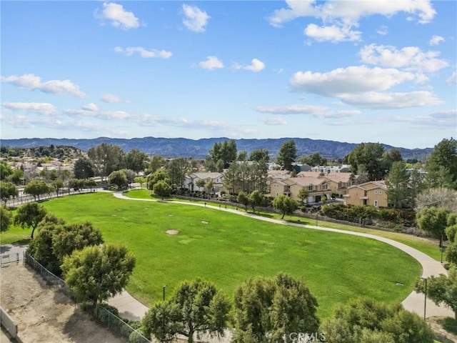 surrounding community featuring a mountain view, fence, and a residential view