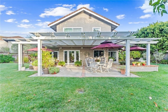 back of property featuring stucco siding, a lawn, a patio, and a pergola