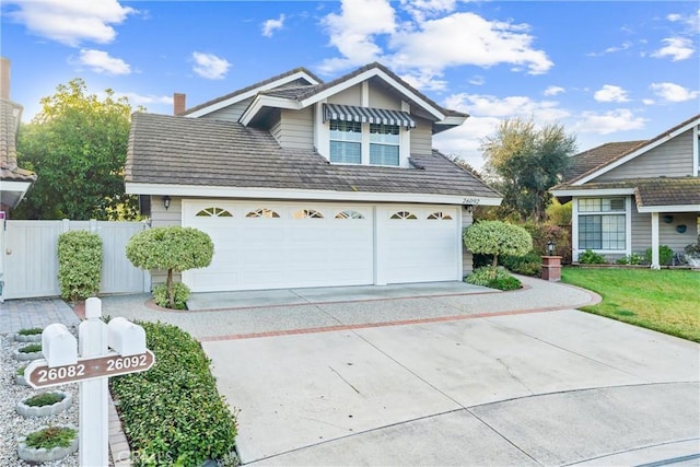 garage with driveway and fence