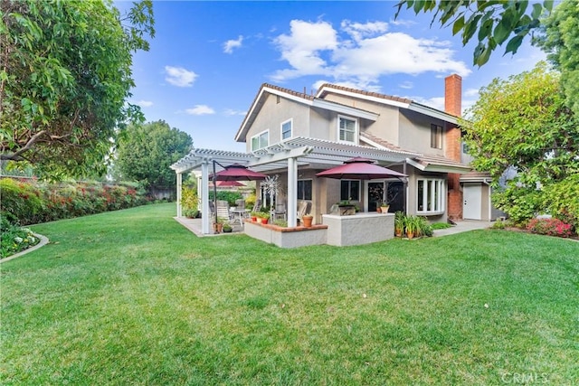 rear view of property featuring stucco siding, a chimney, a pergola, and a yard