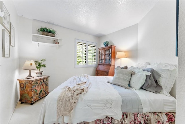 carpeted bedroom featuring a textured ceiling