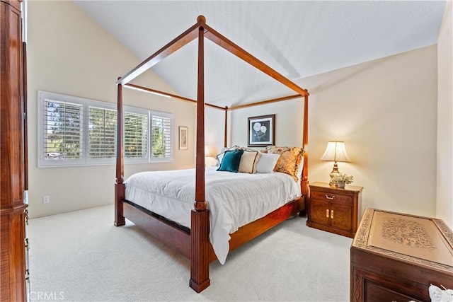 bedroom featuring vaulted ceiling and light colored carpet