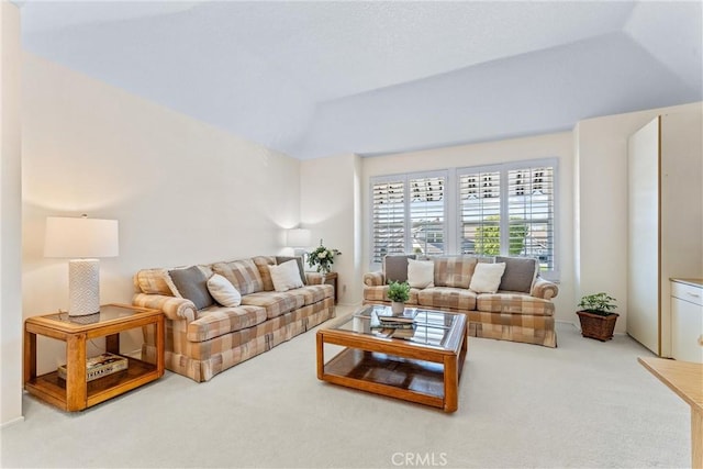 living area featuring lofted ceiling and carpet