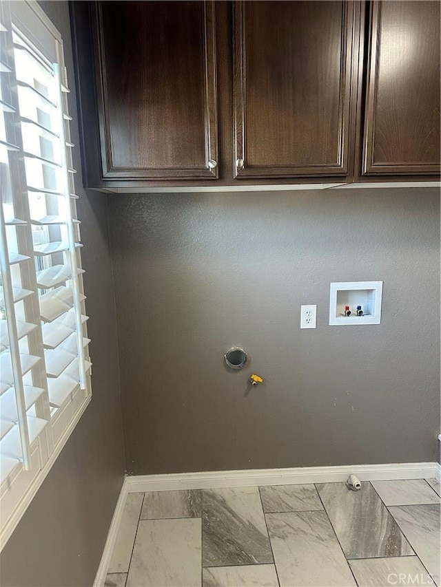 clothes washing area with marble finish floor, baseboards, hookup for a washing machine, gas dryer hookup, and cabinet space