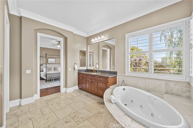 bathroom with tiled bath, ceiling fan, crown molding, and vanity