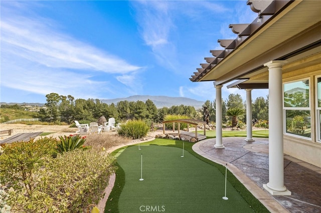 view of community with a mountain view and a patio