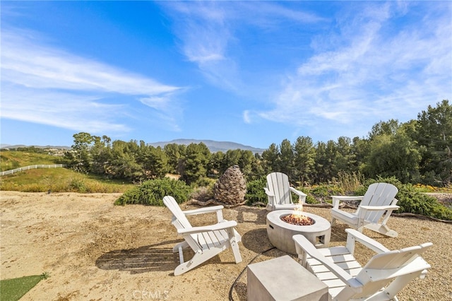 view of patio / terrace featuring a mountain view and an outdoor fire pit