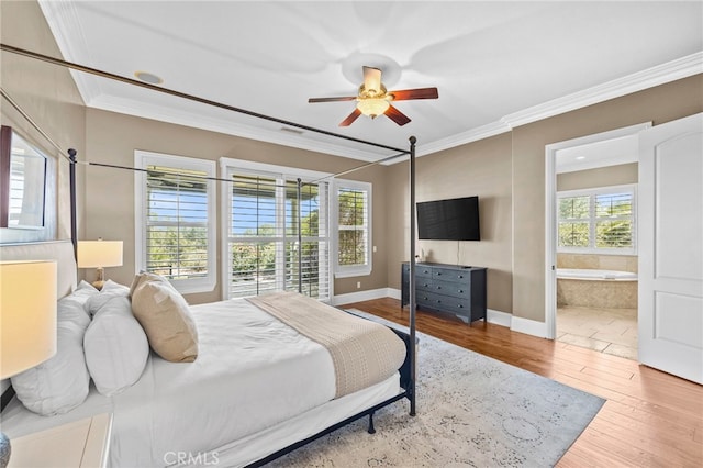 bedroom with connected bathroom, hardwood / wood-style flooring, ceiling fan, and ornamental molding