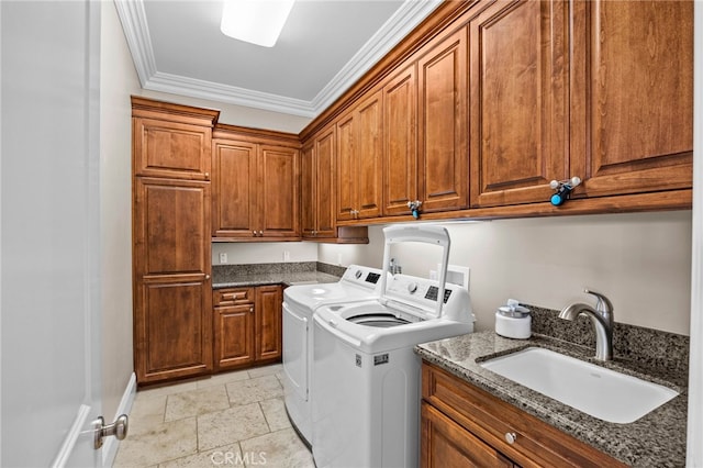 washroom with sink, cabinets, independent washer and dryer, and ornamental molding