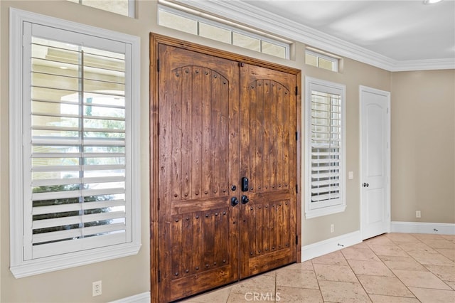 foyer entrance featuring plenty of natural light and crown molding