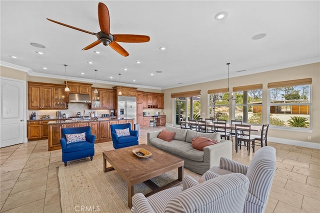 living room with ceiling fan and crown molding