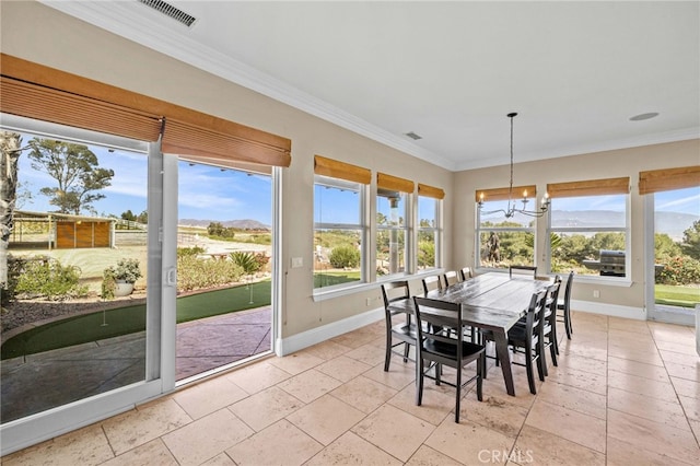 sunroom with a mountain view and an inviting chandelier