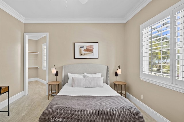 carpeted bedroom featuring ceiling fan and ornamental molding