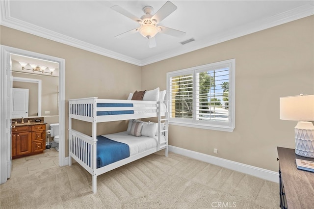 carpeted bedroom featuring ensuite bathroom, ceiling fan, sink, and ornamental molding