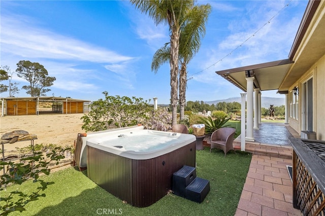 view of yard featuring a hot tub and a patio