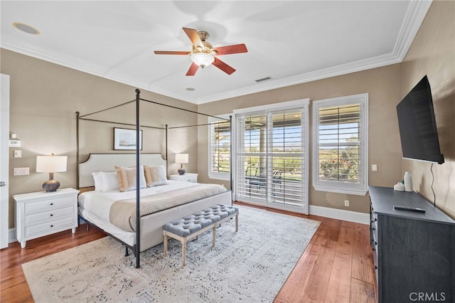 bedroom featuring hardwood / wood-style flooring, crown molding, and access to outside