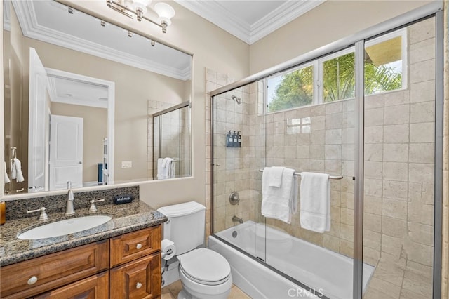 full bathroom with ornamental molding, vanity, bath / shower combo with glass door, and toilet