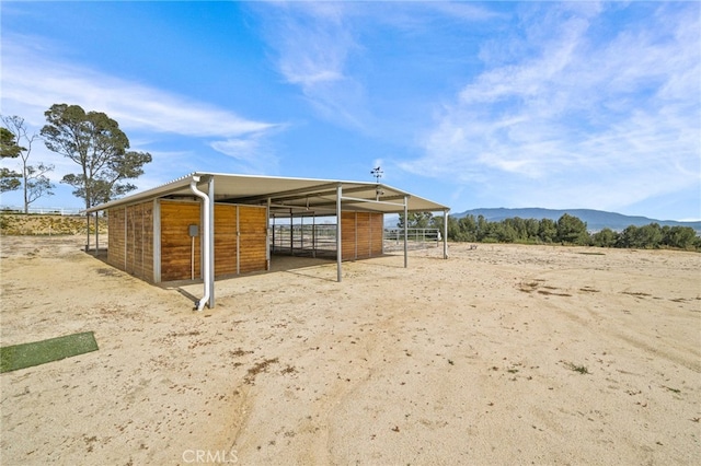 view of horse barn with a mountain view