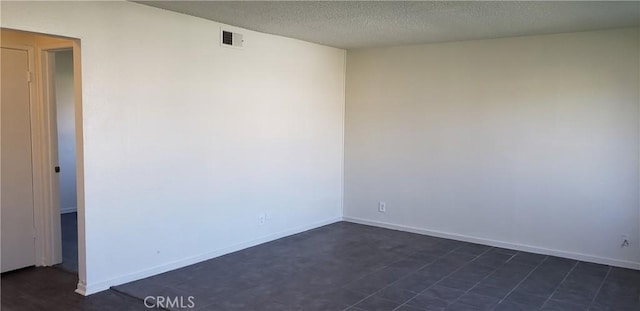 empty room with a textured ceiling