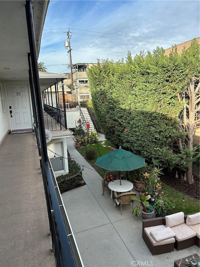 view of patio featuring a balcony