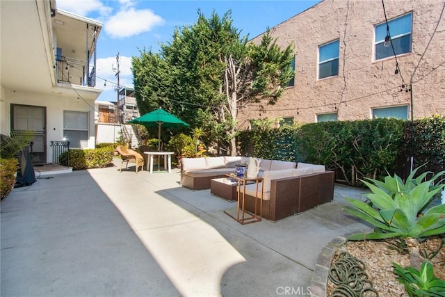 view of patio / terrace featuring outdoor lounge area and fence