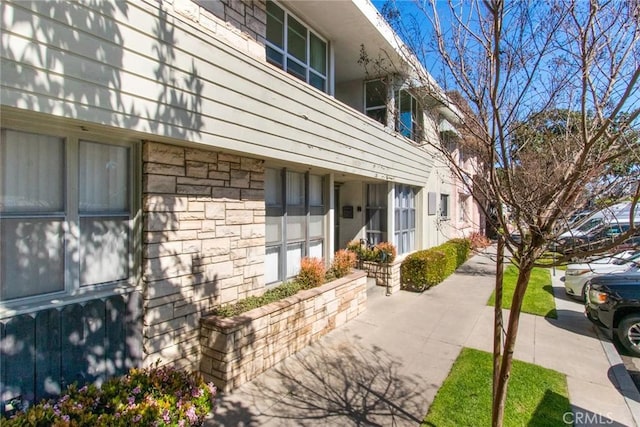 view of side of home with stone siding