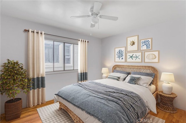 bedroom with wood finished floors and a ceiling fan