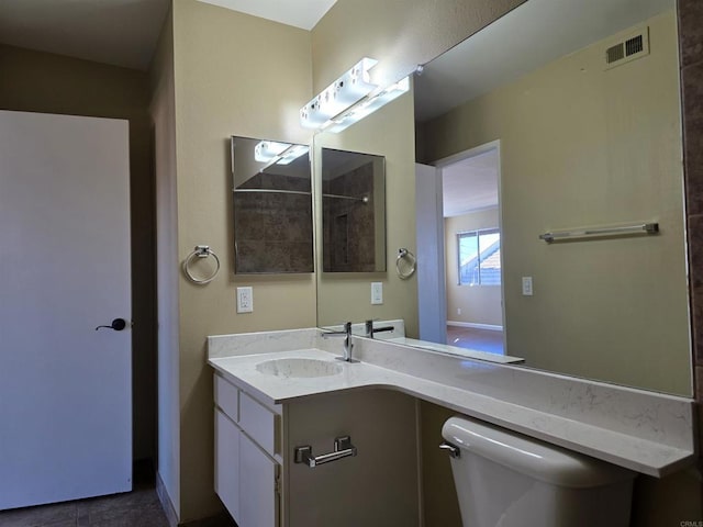 full bath with toilet, visible vents, and vanity