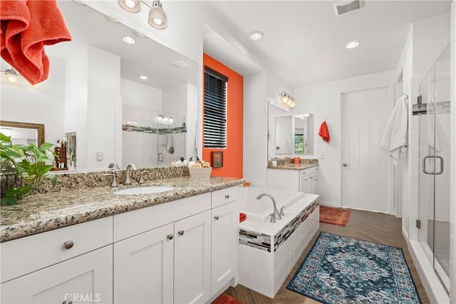 bathroom featuring separate shower and tub and vanity