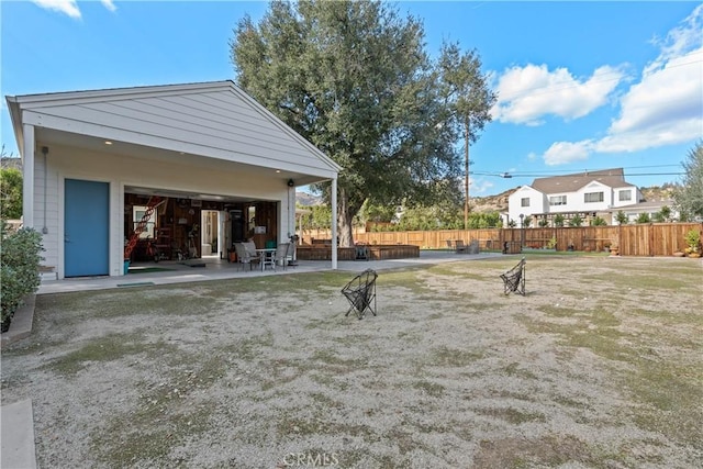 view of yard with fence and a patio