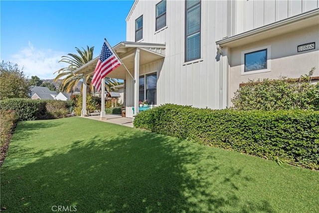 rear view of property with a lawn