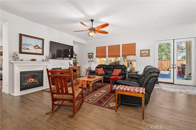 living room featuring hardwood / wood-style flooring, ceiling fan, and french doors