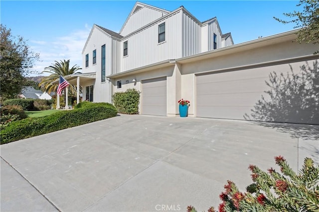 view of front of property featuring concrete driveway and an attached garage