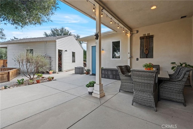 view of patio / terrace featuring outdoor dining area, central AC, and an outdoor structure