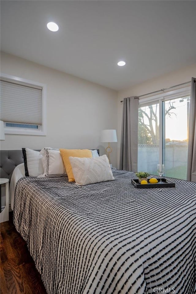 bedroom featuring access to exterior and dark wood-type flooring