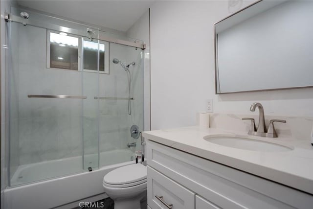 full bathroom with vanity, shower / bath combination with glass door, and toilet