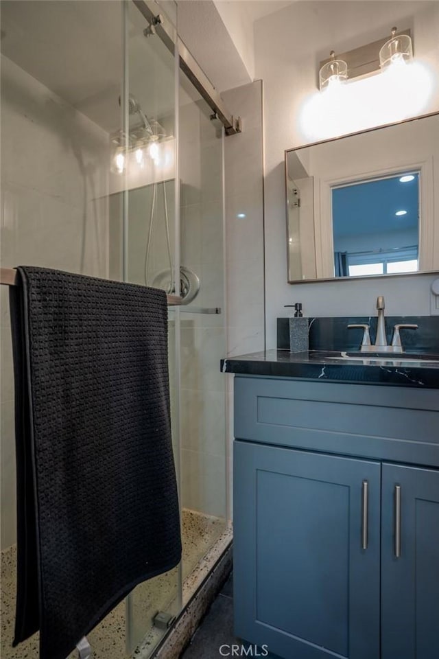 bathroom with walk in shower and vanity