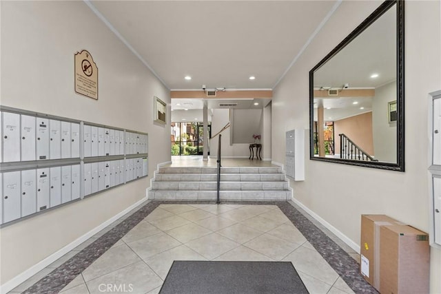 hallway featuring ornamental molding, a mail area, and light tile patterned flooring