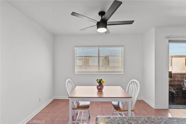 dining area with light tile patterned floors and ceiling fan