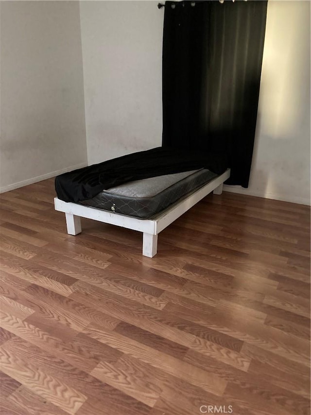 unfurnished bedroom featuring hardwood / wood-style floors