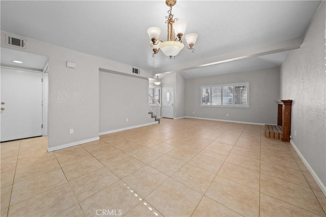 tiled empty room with beam ceiling and a chandelier