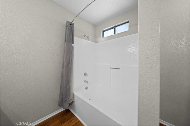 bathroom featuring shower / tub combination and hardwood / wood-style floors