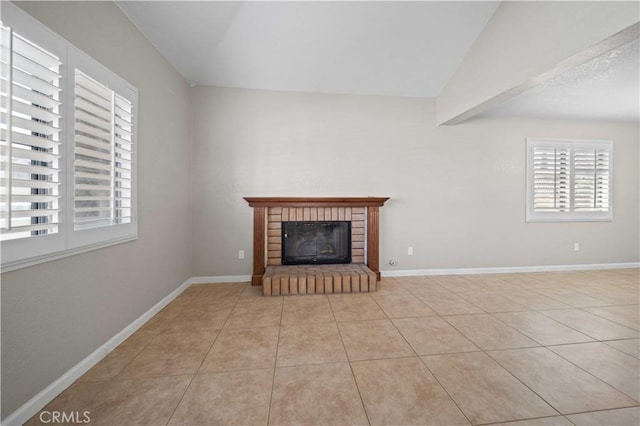 unfurnished living room featuring vaulted ceiling with beams, light tile patterned floors, and a brick fireplace