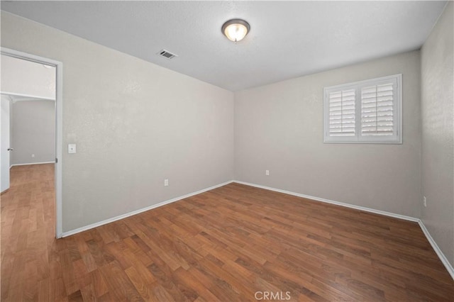 empty room featuring hardwood / wood-style flooring