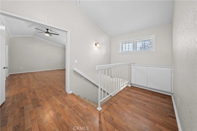 interior space with lofted ceiling, hardwood / wood-style flooring, and ceiling fan