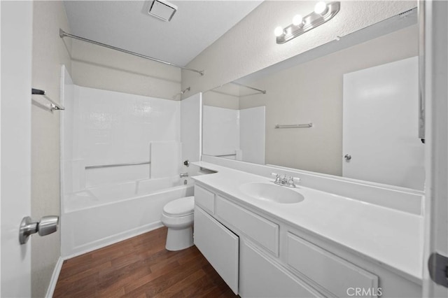 full bathroom with shower / washtub combination, hardwood / wood-style floors, vanity, and toilet