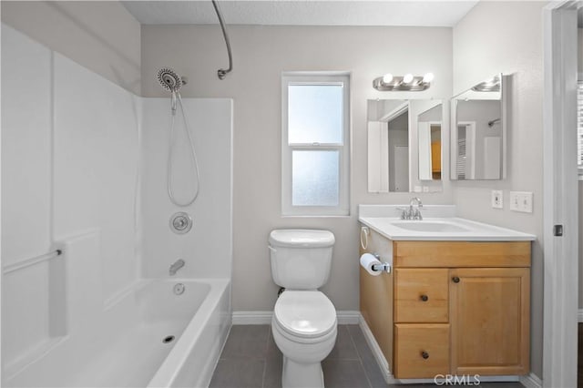 full bathroom with vanity, tile patterned floors, washtub / shower combination, and toilet