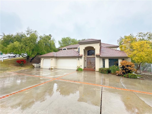 mediterranean / spanish house featuring a garage