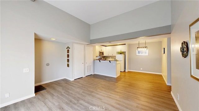 unfurnished living room featuring light hardwood / wood-style flooring