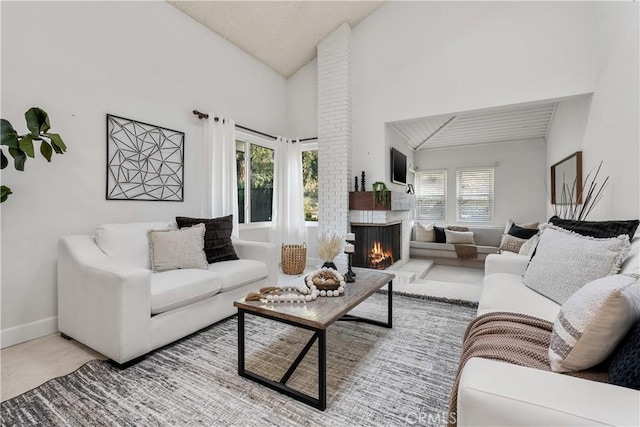 living room featuring carpet flooring and high vaulted ceiling